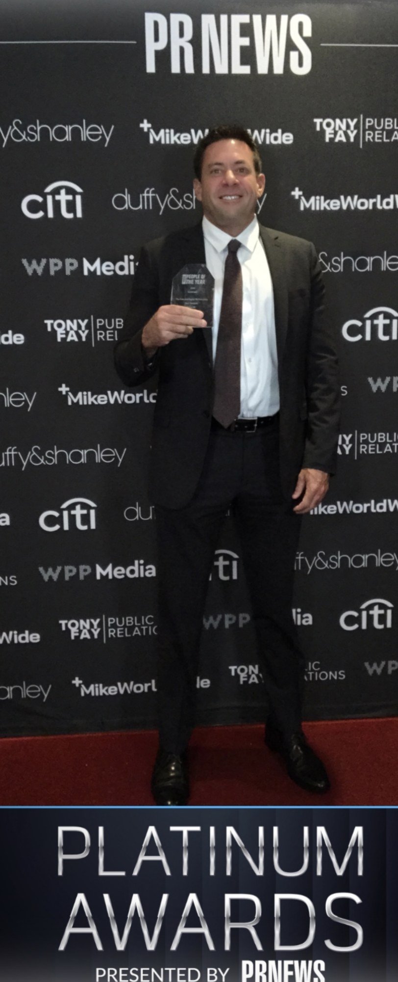 Rick Pendrick holding his 2026 PR News Person of the Year award at the PR News Platinum Awards gala